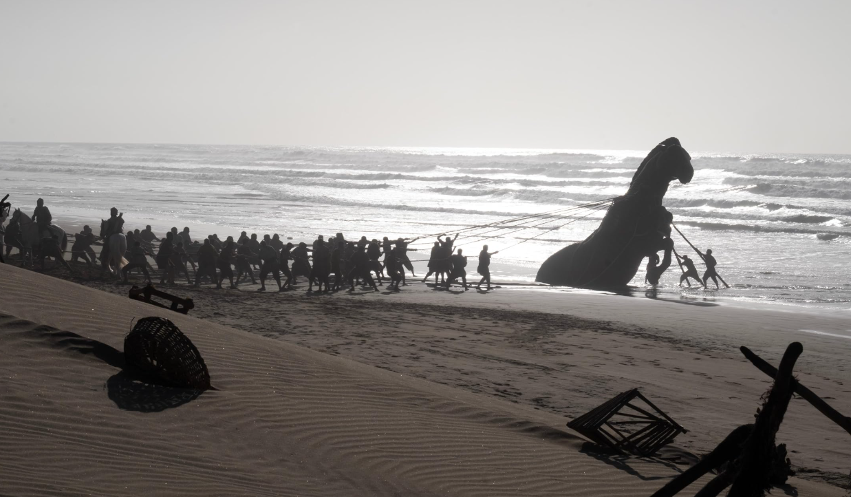 Soldiers pulling out the horse from the sand in The Odyssey